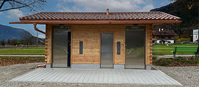 WC facility with wooden facade, front view”