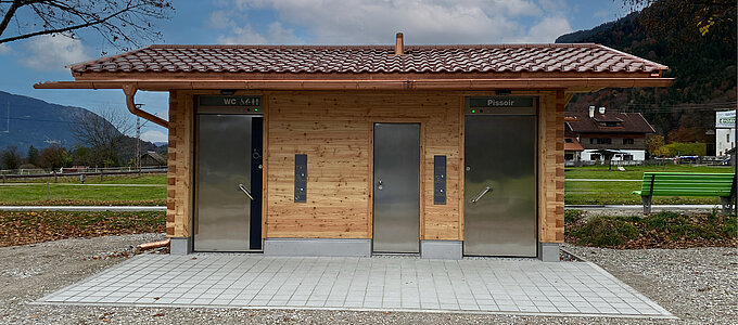 WC facility with wooden facade, front view”