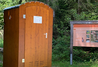 Self-contained public toilet facility along a hiking trail