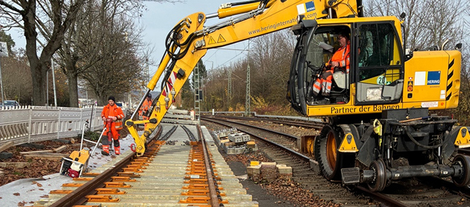 Dual-mode excavator and crew during turnout installation