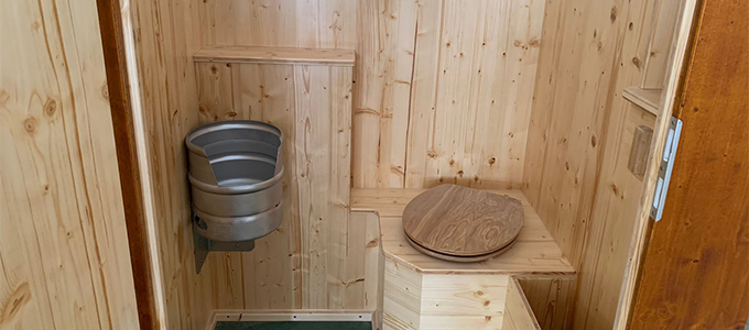 Interior of a self-contained toilet facility with wooden elements